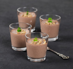 Italian dessert Panna cotta chocolate nut in a glass on a dark background