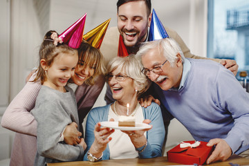Cheerful extended family celebrating Birthday at home.