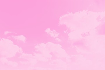 Pink sky background with soft delicate clouds. Copy space