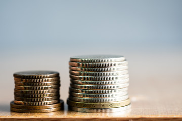 Group of coins on blurred background in business concept.