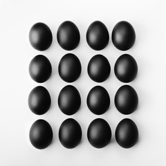 Square composition of sixteen black eggs. Minimalist concept