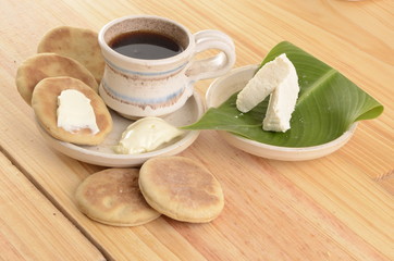 arepa de trigo venezolana con queso cuajado y taza de café caliente