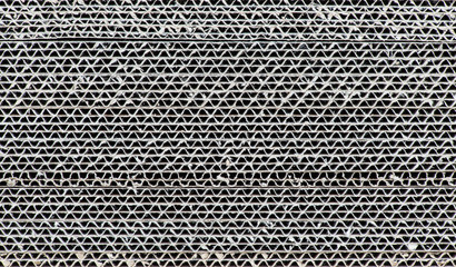 used corrugated cardboard, for recycling. abstract background horizontal lines with wavy beige lines
