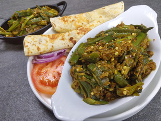 Bhindi Masala or stuffed Bhindi or okra, an Indian vegetable  on a plate with copy space.