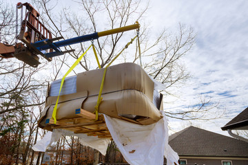 Lifting Boom Lift in modern jacuzi are lifting by boom truck