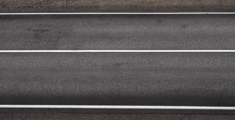 Asphalt highway texture with three white stripes