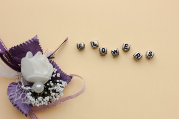 Word flowers made of cubes on a yellow background. Paper and flower