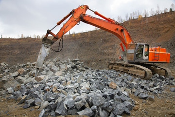 The excavator works in a quarry, mining equipment, mining of rubble, sand, clay