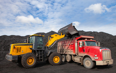 Loading coal into a truck with an excavator. Mine