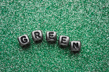 Word green made of cubes on a green background. Color texture