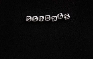  Word science made of cubes on a black background