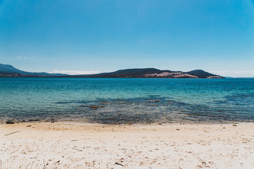 wild Tasmanian landscape and pristine turquoise water of the Derwent River as seen from Legacy Beach near Coningham beach south of Hobart