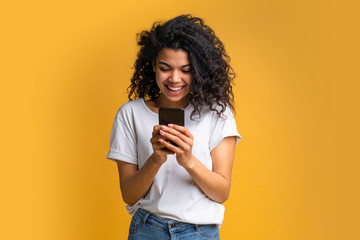 Portrait of attractive young african american girl using mobile phone - 325894432