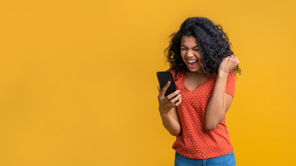 Portrait of attractive young african american girl using mobile phone