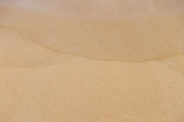 Fototapeta na wymiar Natural sand texture background, wave pattern on blank brown sand background