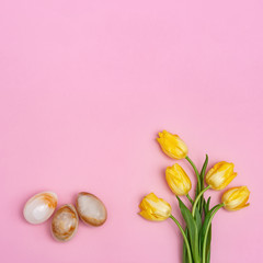 Easter composition with natural flower of tulips and decorative eggs from gemstone onyx. Spring Easter holiday flat lay composition with copy space.
