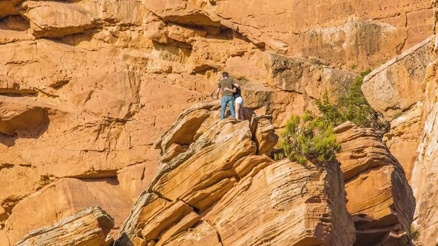 A Couple Taking A Selfie On The Edge Of The Boulder On A Summer Weather. -wide shot