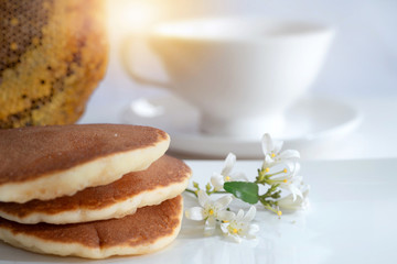 White flowers or Orange jasmine with stack of pancakes on white background, honeycomb in background