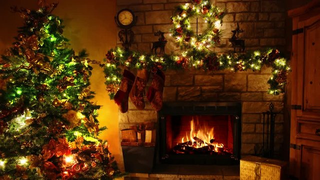 Fabulous 4k shot of firewood flame burning fireplace loop in cosy festive Christmas tree New Year decoration Noel room