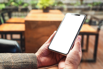 Mockup image of a woman holding mobile phone with blank white screen