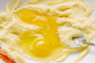 The process of making dough for baking. Bowl with flour, yolk and sugar