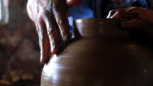 Potter hands working with mud