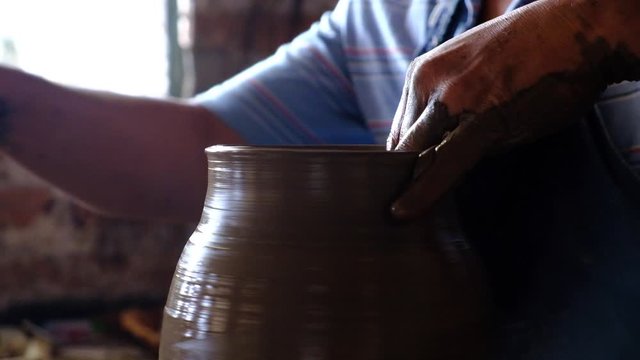 Potter hands working with mud