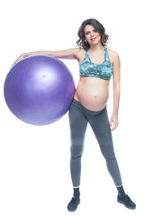 Fototapeta premium Portrait of a beautiful young pregnant woman exercises with fitball. Working out and fitness, pregnancy concept. Isolated white background.