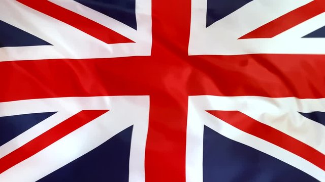 UK flag waving in the wind close-up. The wind is blowing from right to left. Background for news, movies and more.