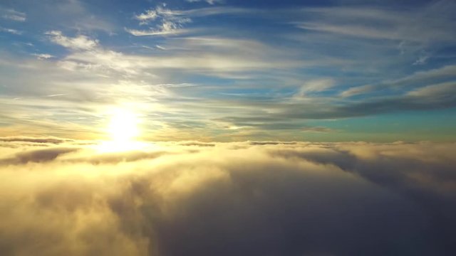 Stunning aerial helicopter drone view flight over white rain fluffy cloud in blue sky evening sunset sunshine cloudscape