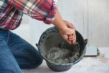Construction technicians working with cement paving, cement mix with the trowel at the side work,...