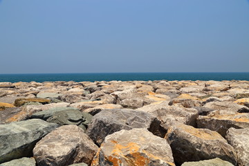Fototapeta na wymiar Sea coast coastline, rock breakwater at Dubai, United Arab Emirates