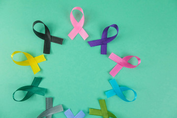 Close up of cancer ribbons on  mint background. Cancer awareness month.