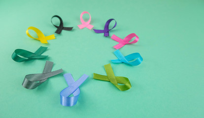 Close up of cancer ribbons on  mint background. Cancer awareness month.