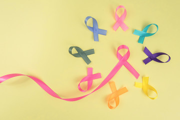 Close up of cancer ribbons on  yellow background. Cancer awareness month.
