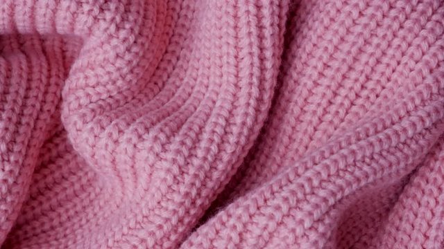 pink knitted fabric as a background. macro