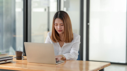 Close up view of businesswoman working while sitting at her working place