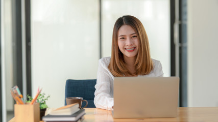 Cropped shot of female entrepreneur working while sitting at her working place