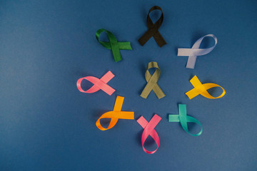 Close up of cancer ribbons on  royal blue background. Cancer awareness month.