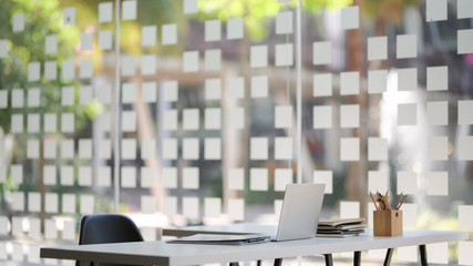 Cropped shot of modern office room with laptop computer and office supplies