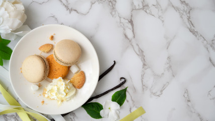 Top view of Colourful Pastel Macarons on white ceramic plate