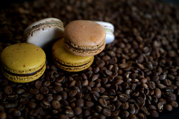 Close up view of coffee and chocolate macarons on coffee bean