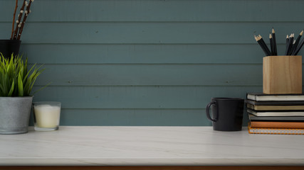 Obraz premium Close up view of workspace with stationery, coffee cup, decorations and copy space on marble desk