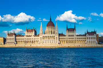 Obraz na płótnie Canvas Budapest, Hungary - CIRCA 2013: Hungarian Parliament Building, as photographed from across the Danube; at a bright sunny summer day.