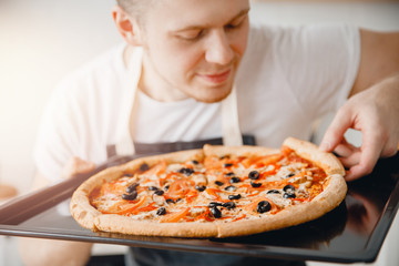 Man tries slice of fresh Italian hot pizza, sunlight