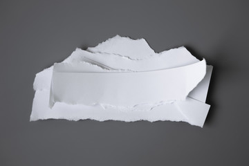 white torn paper on gray background. collection paper rip