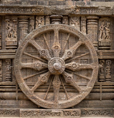 A stone wheel depicting time of a day