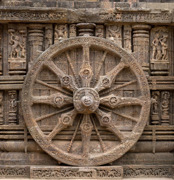 A stone wheel depicting time of a day