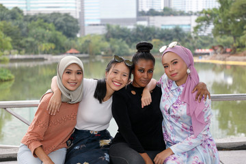 Group of woman Malay Chinese Indian Malaysian  hug friends togetherness unity outdoor green park lake nature