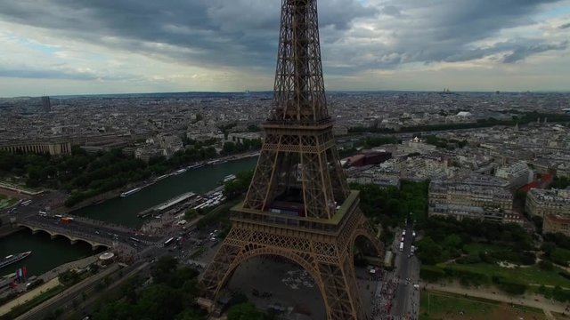 Amazing aerial drone shot of Eiffel Tower national symbol Paris France Champ Mars tall steel monument cloudy cityscape